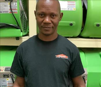 man SERVPRO air movers green background employee African American 