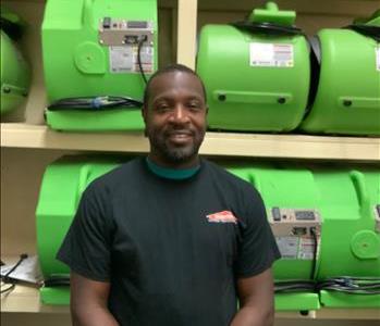 man smiling SERVPRO air movers green background employee
