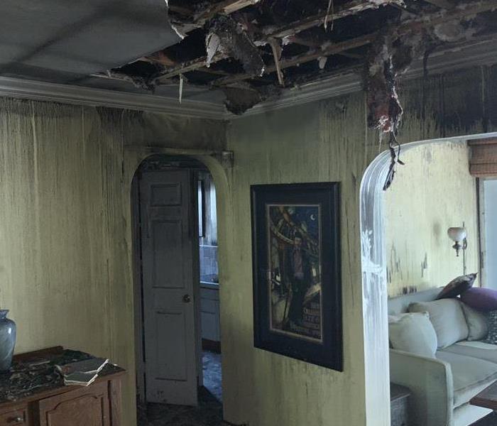 fire damage home living room Florida Dania beach roof damage burned